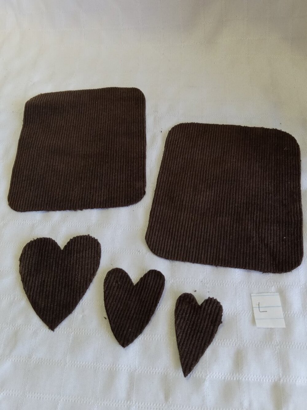 Two handmade elbow patches for sewing made of brown corduroy with hearts